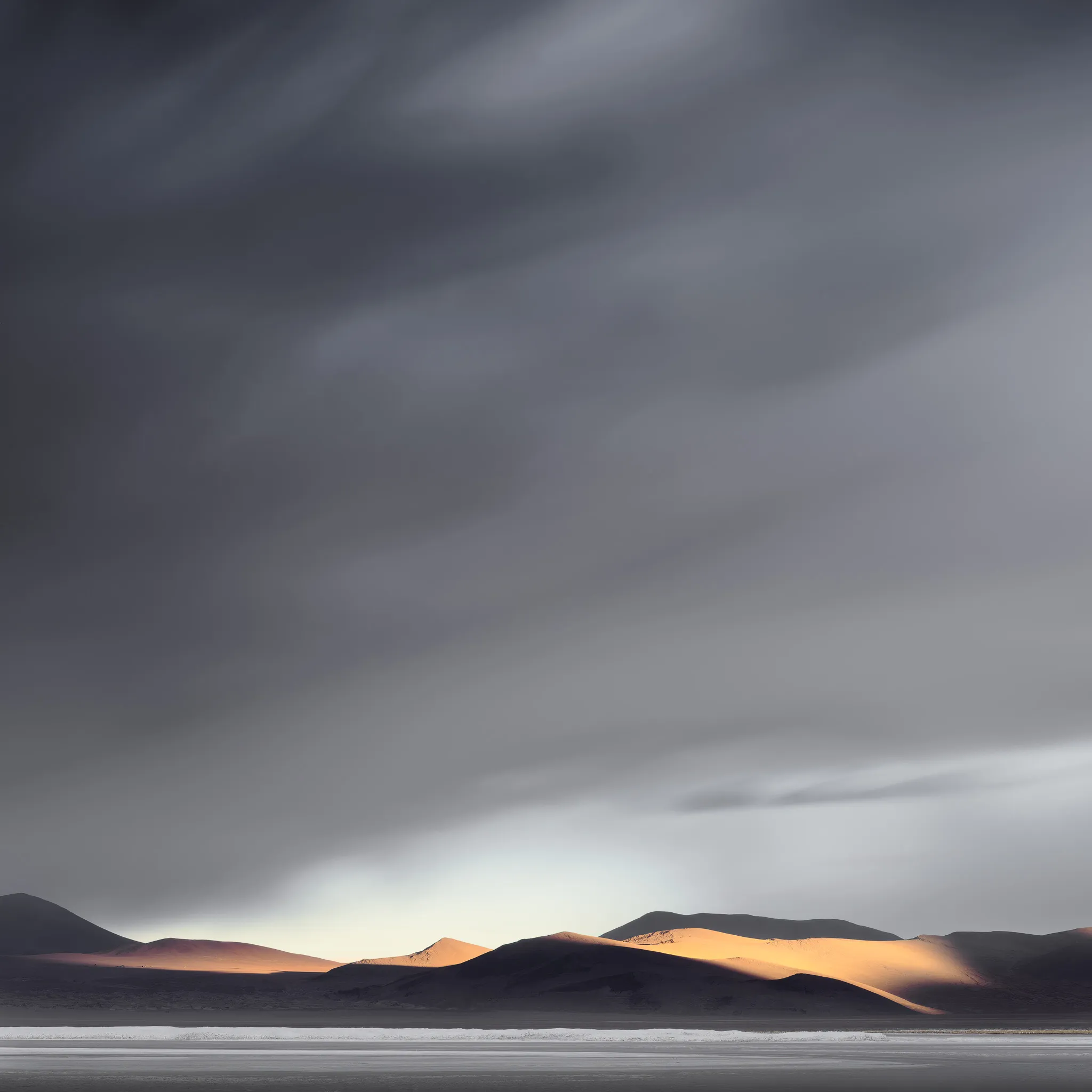Low dunes catching warm side-light beneath a dark, brooding sky above a pale salt flat