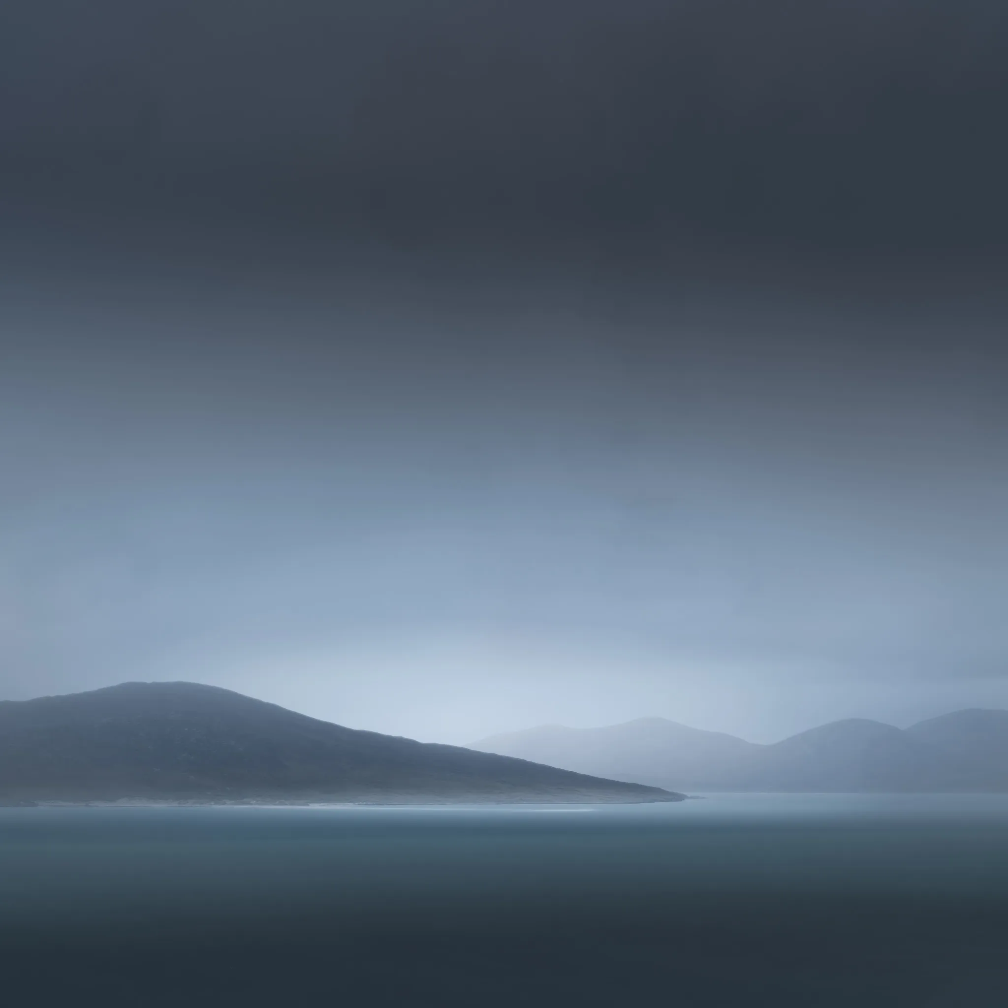 Layered misty headlands and a calm sea in soft blue-teal light